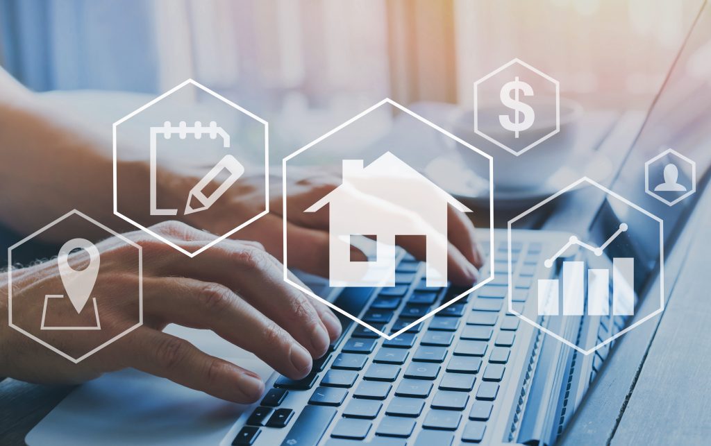 An image of a person typing on a laptop with hexagons of different real estate icons over the top.