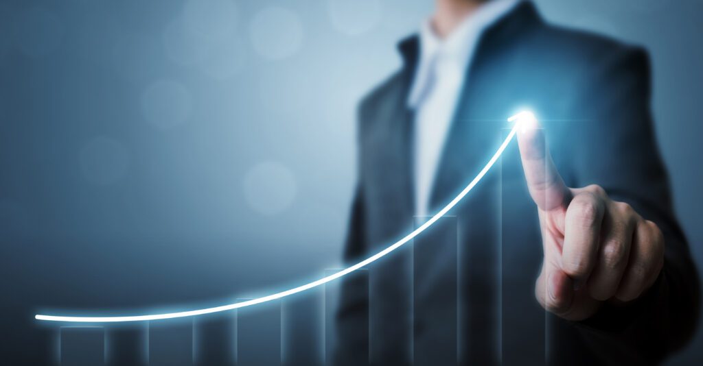 An upward-sloping line with a man’s finger touching the arrow to conceptualize business growth.