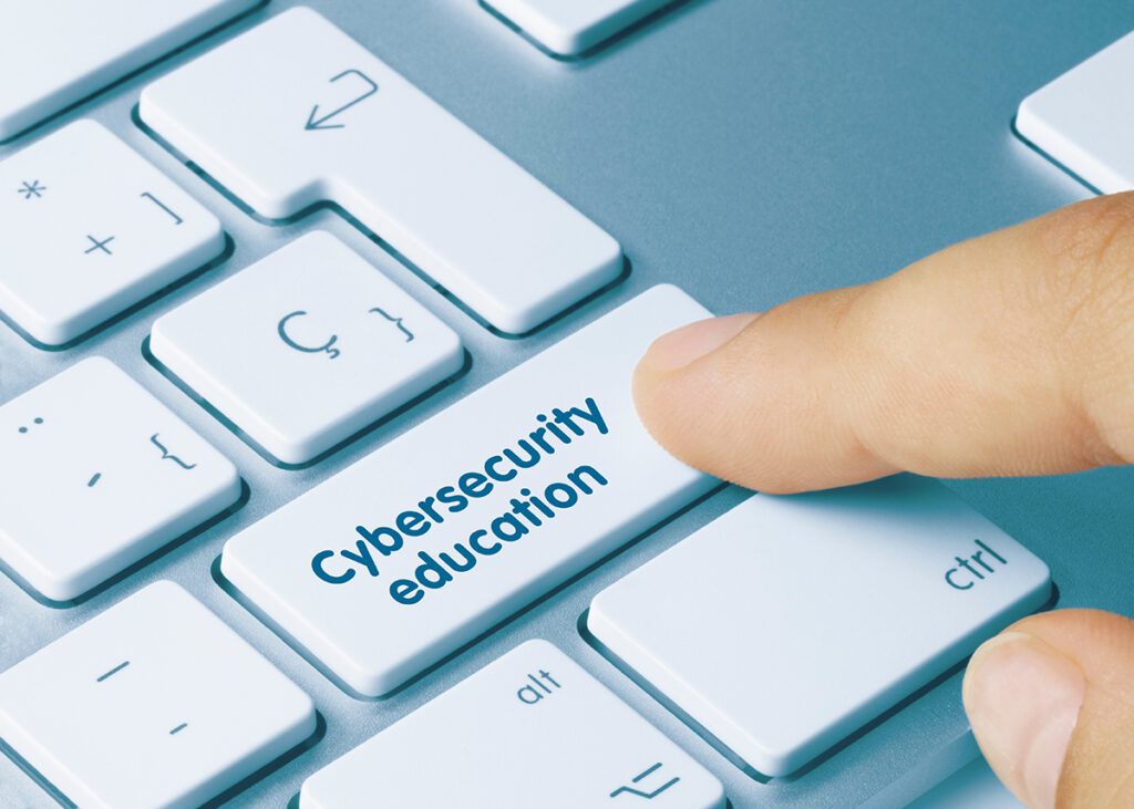 A person pressing a button that reads “cybersecurity education”