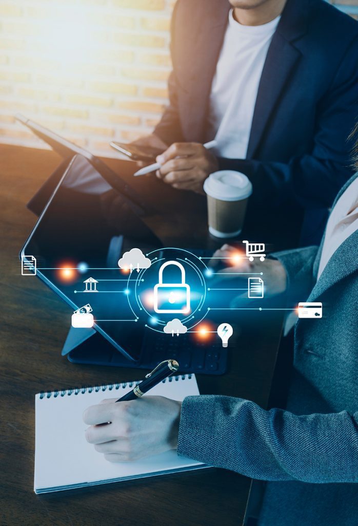 a pair of professionals discuss cyber incidents over tablets with superimposed representations of security hovering over the screens