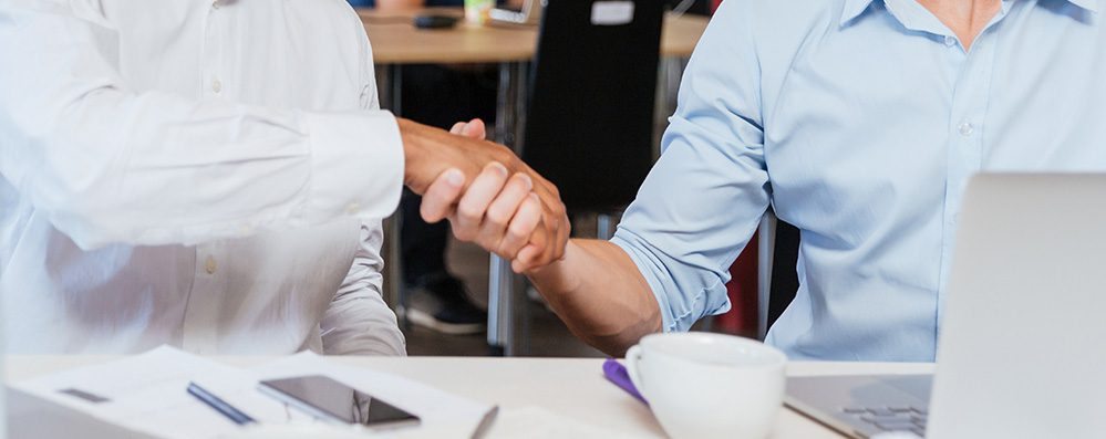 Two happy businessmen shaking hands
