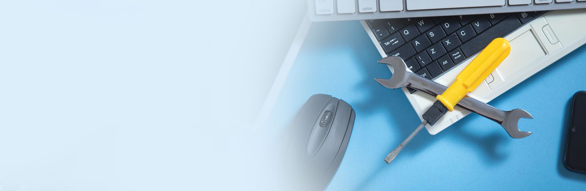 Wrench and screwdriver with a computer keyboard, smartphone, tablet, mouse. IT Service. Support