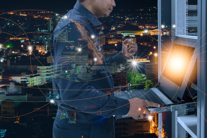 Network administrator expresses the joy of successfully connecting to the network in data center with city night background and connection line, concept of success in business