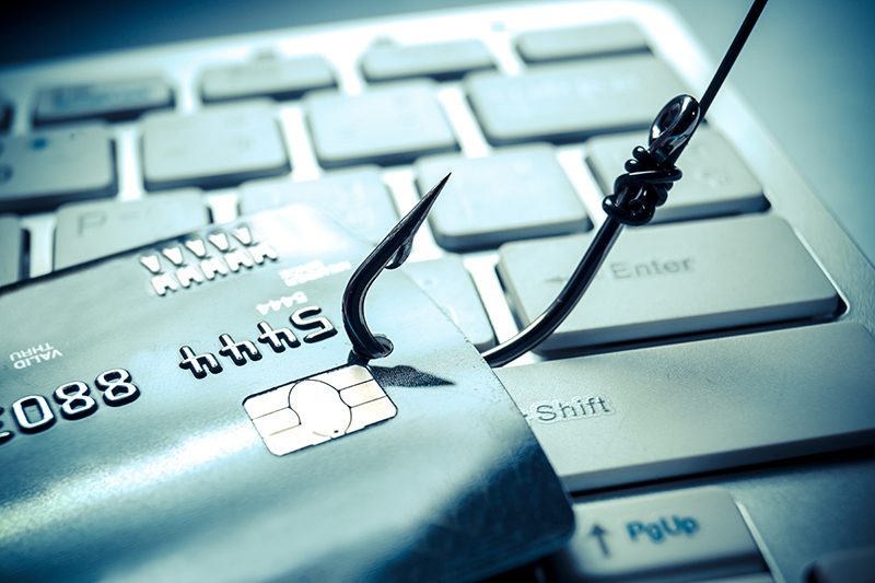 an image of a credit card on a fishing hook over a computer